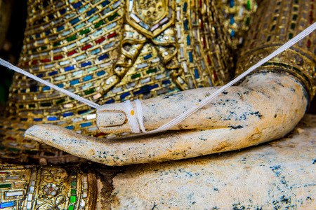 Hand of buddha at Thai temple, Thailand.の写真素材
