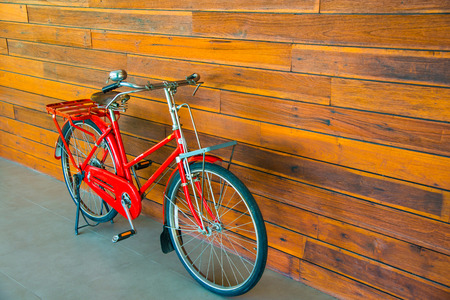 Vintage bicycle with wooden wall, Thailand.の写真素材