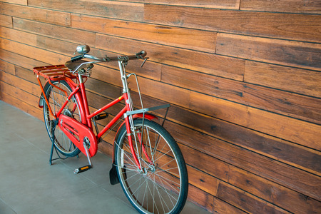 Vintage bicycle with wooden wall, Thailand.の写真素材