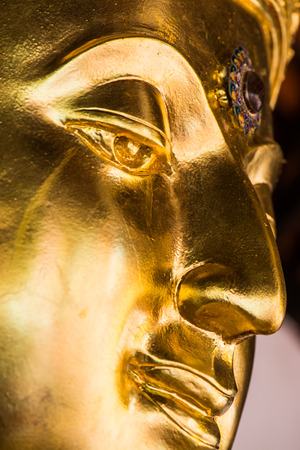 Face of golden buddha sculpture, Thailandの写真素材