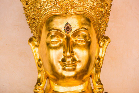 Face of golden buddha sculpture, Thailandの写真素材