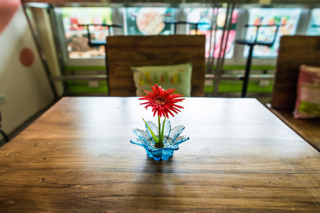 Little Gerbera flower on wooden table, Thailandの写真素材