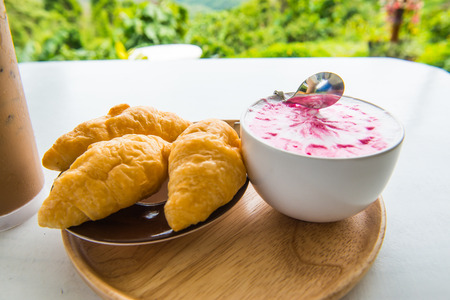 Hot fresh milk with fresh croissants on white table, Thailandの写真素材