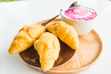 Hot fresh milk with fresh croissants on white table, Thailandの写真素材