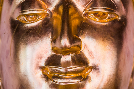 Face of golden buddha sculpture, Thailandの写真素材