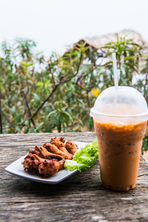 Thai style fried chicken with iced milk tea, Thailandの写真素材