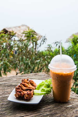 Thai style fried chicken with iced milk tea, Thailandの写真素材