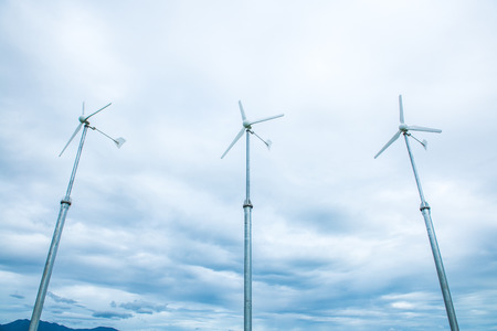 Small windturbine on white sky, Thailand.の写真素材