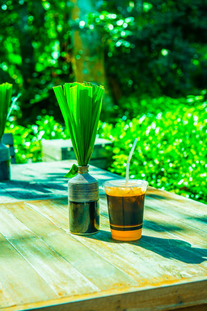 Iced milk tea with modern vase on the table, Thailand.の写真素材