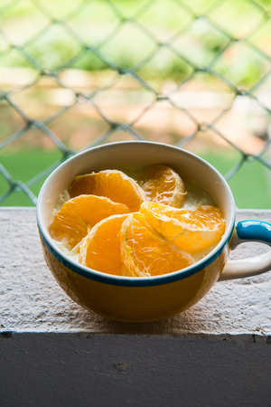 Orange Cheese Cake in Yellow Cup, Thailand.の写真素材
