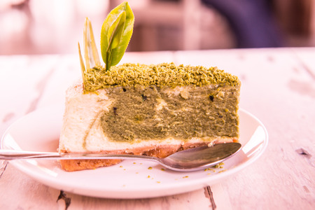 Green Tea Cheesecake on White Dish, Thailand.の写真素材
