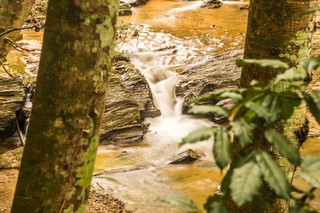 Water flowing at Mork Fa waterfall, Thailand.の写真素材