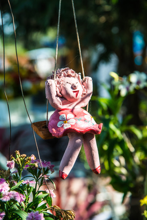 Lovely ceramic doll in park, Thailand.の写真素材