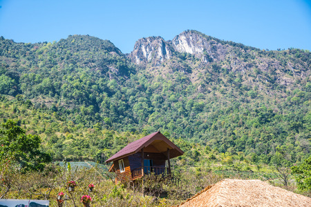 Small house with mountain background, Thailand.のeditorial素材