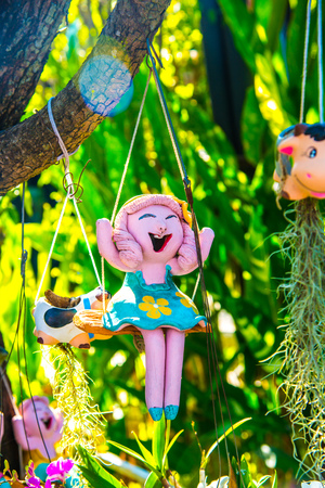 Lovely ceramic doll in park, Thailand.の写真素材