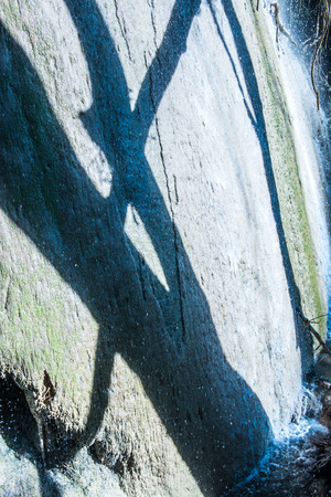 Water flowing with tree shadow on stone, Thailand.の写真素材
