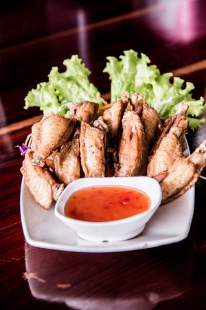 Fried chicken with fish sauce on modern plate, Thailand.の写真素材