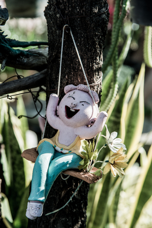 Lovely ceramic doll in park, Thailand.の写真素材