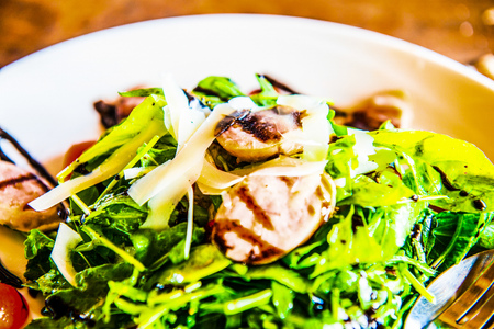 Italian sausage and rocket salad on white dish, Thailand.の写真素材