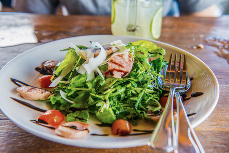 Italian sausage and rocket salad on white dish, Thailand.の写真素材