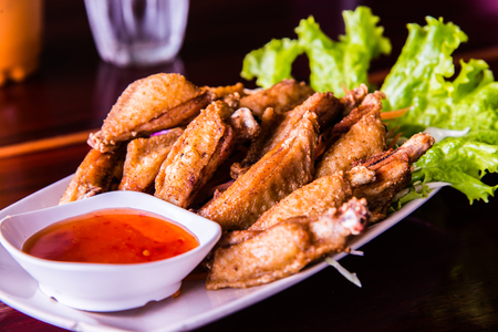 Fried chicken with fish sauce on modern plate, Thailand.の写真素材