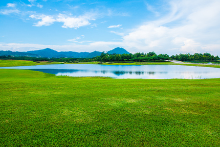 Green grass yard with lake, Thailand.の写真素材