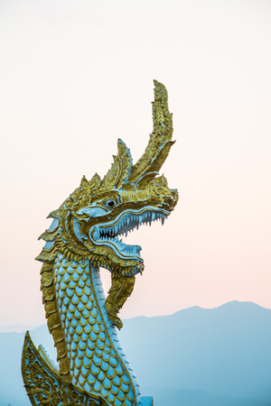White Naga statue at Kwan Phayao with evening sun, Thailand.の写真素材