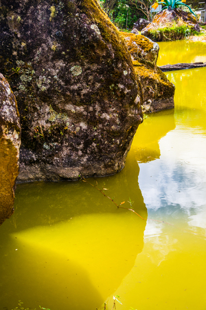 Ancient stone with green lake at Chiangmai province, Thailand.の写真素材