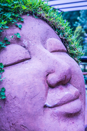 Ceramic doll with grass on head, Thailand.