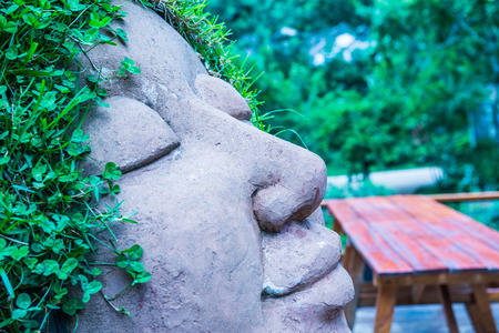 Ceramic doll with grass on head, Thailand.の写真素材