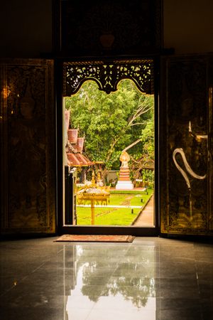 Silhouette of church door at Darabhirom forest monastery, Thailand.のeditorial素材