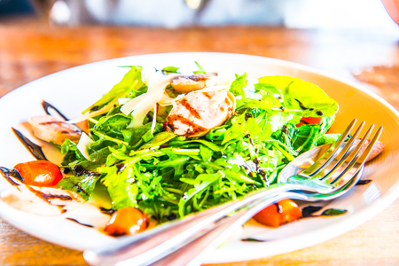 Italian sausage and rocket salad on white dish, Thailand.の写真素材