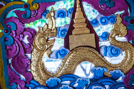 Lanna style wood carving in temple, Thailand.の写真素材