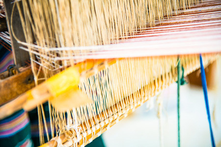 Native thread on Thai traditional weaving machine, Thailand.