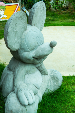 LAMPHUN, THAILAND - July 12, 2015 : Mickey mouse statue on grass floor, Thailand.のeditorial素材