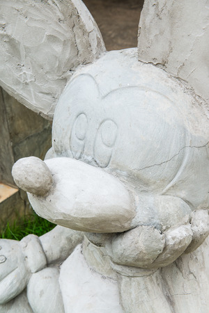 LAMPHUN, THAILAND - July 12, 2015 : Mickey mouse statue on grass floor, Thailand.のeditorial素材