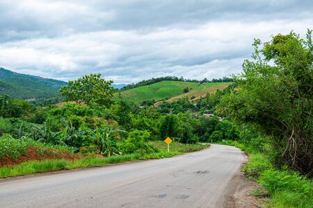 Agricultural area on mountain with road of Mae Chaem district in Chiang Mai province, Thailand.の写真素材