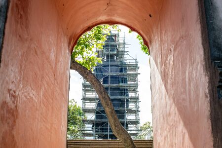 Big Standing Buddha under renovation with door frame in  Analyo Thipayaram temple, Thailand.の写真素材
