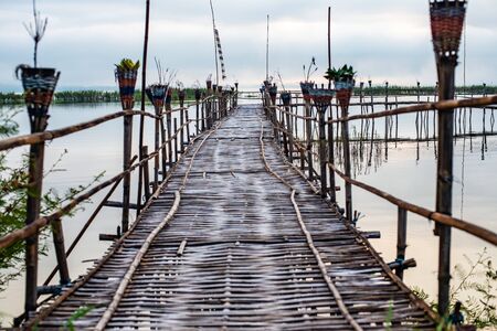 Small wooden bridge with Kwan Phayao lake at sunrise, Thailand.の写真素材
