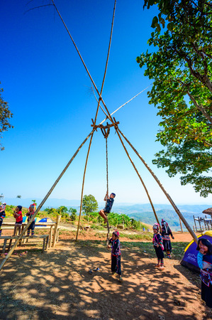 CHIANG RAI, THAILAND - December 14, 2019 - Hill tribe childrens are playing wooden swing at Doi Sa Ngo viewpoint, Chiang Rai province.のeditorial素材