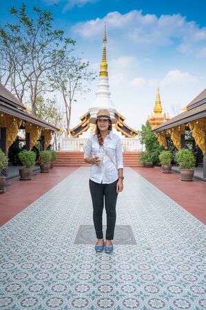 Asian woman with Wat Phra That Doi Phra Chan background, Lampang province.