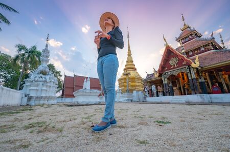 Asian woman with Wat Pong Sanuk background, Lampang province.の写真素材