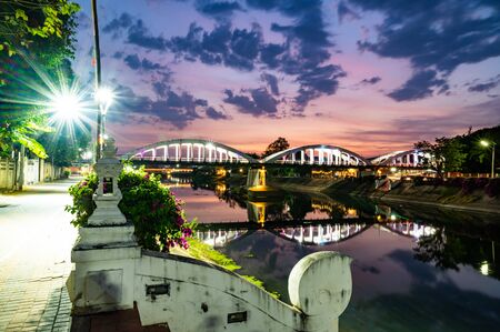 Ratsadaphisek Bridge over Wang River at Night, Lampang Province.の写真素材
