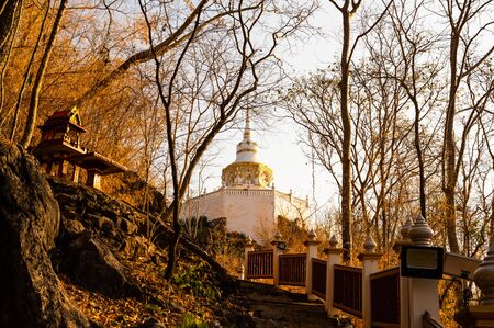 White pagoda with stair walkway at Tham Phra Sabai temple, Lampang province.の写真素材