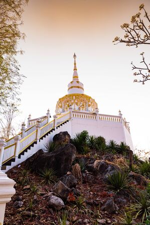 White pagoda with stair walkway at Tham Phra Sabai temple, Lampang province.の写真素材