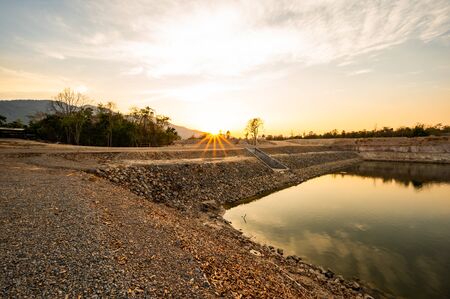 Reservoir with walkway at sunset, Chiang Mai province.の写真素材