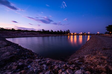 Reservoir with walkway at sunset, Chiang Mai province.の写真素材