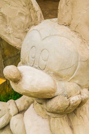 LAMPHUN, THAILAND - July 12, 2015 : Mickey mouse statue on grass floor, Thailand.のeditorial素材