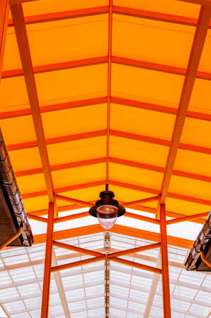 Orange translucent roof or orange skylight roof with lamp, Thailand.の写真素材