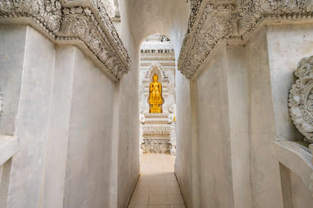 Temple entrance and golden Buddha statue at San Pa Yang Luang temple, Lamphun province.の写真素材